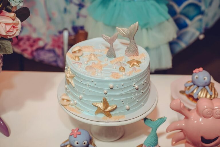 A whimsical mermaid-themed cake adorned with sea-inspired decorations perfect for birthday celebrations.
